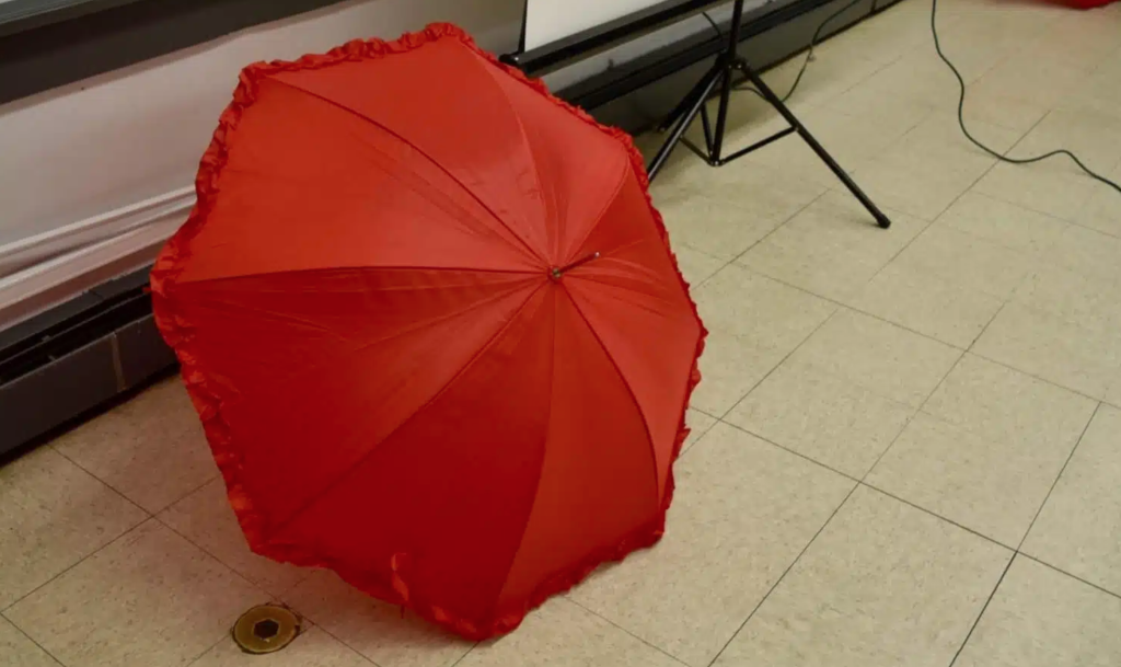 red umbrella on a tile floor