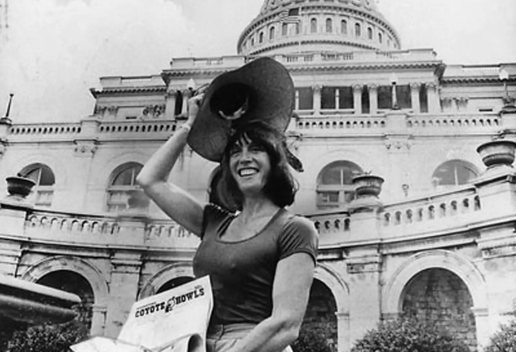 margo st. james in front of the capitol building, holding a coyote bowl newspaper